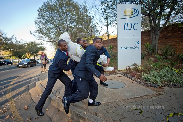 Khotso being unceremoniously escorted from the IDC premises. I love this picture.
